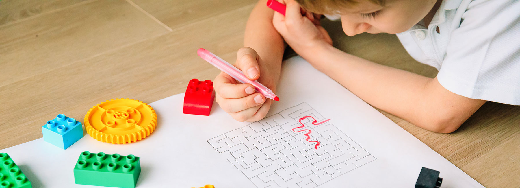 Boy with a marker solving a maze